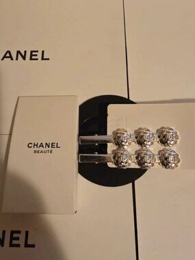 CHANEL SILVER CAMELLIA HAIR CLIPS.